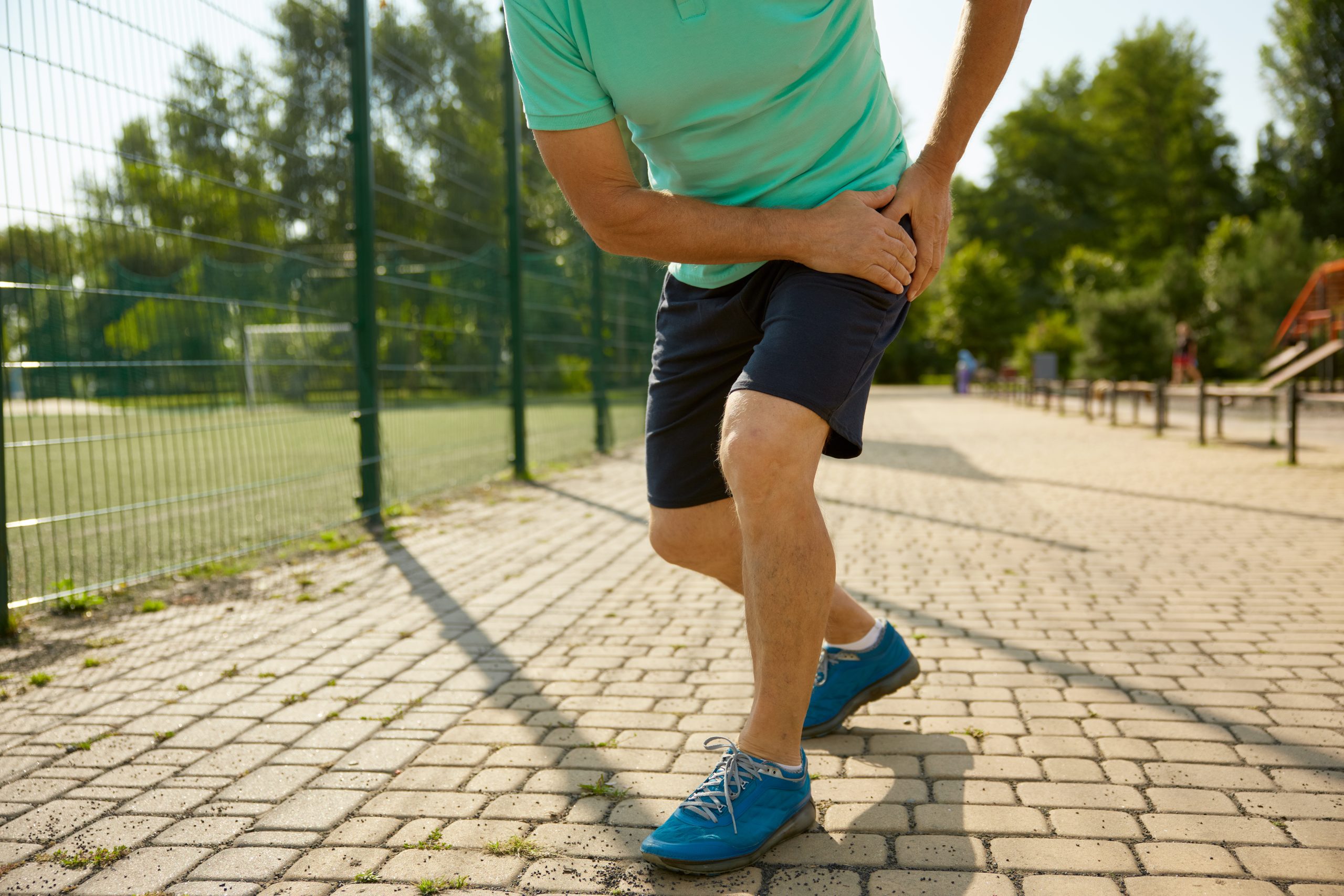 Senior sportsman suffering with knee having injury during workout
