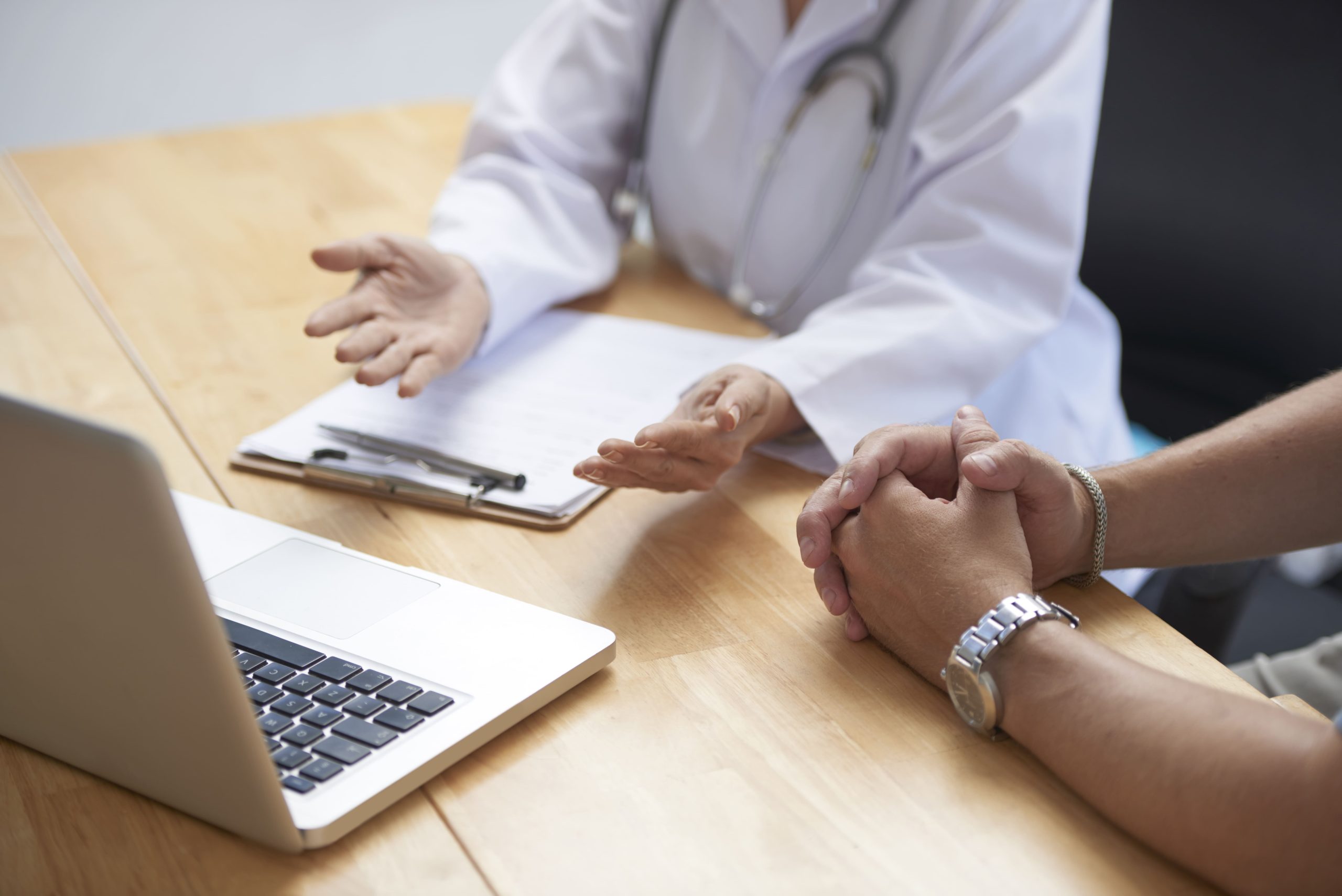 medical-consultation-at-wooden-table-with-laptop-2026-03-18-05-16-23-utc (1)