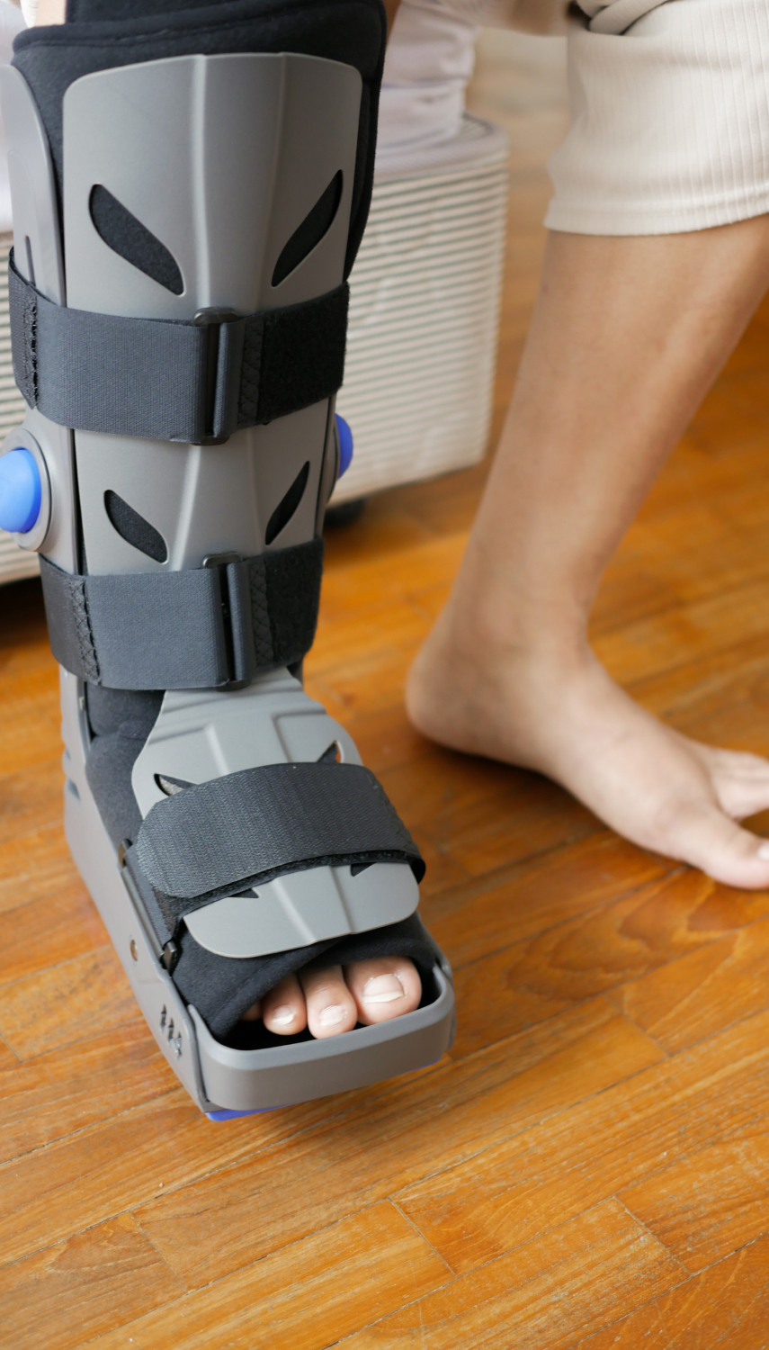 A close-up of a foot in a medical boot, indicating a foot or ankle condition.