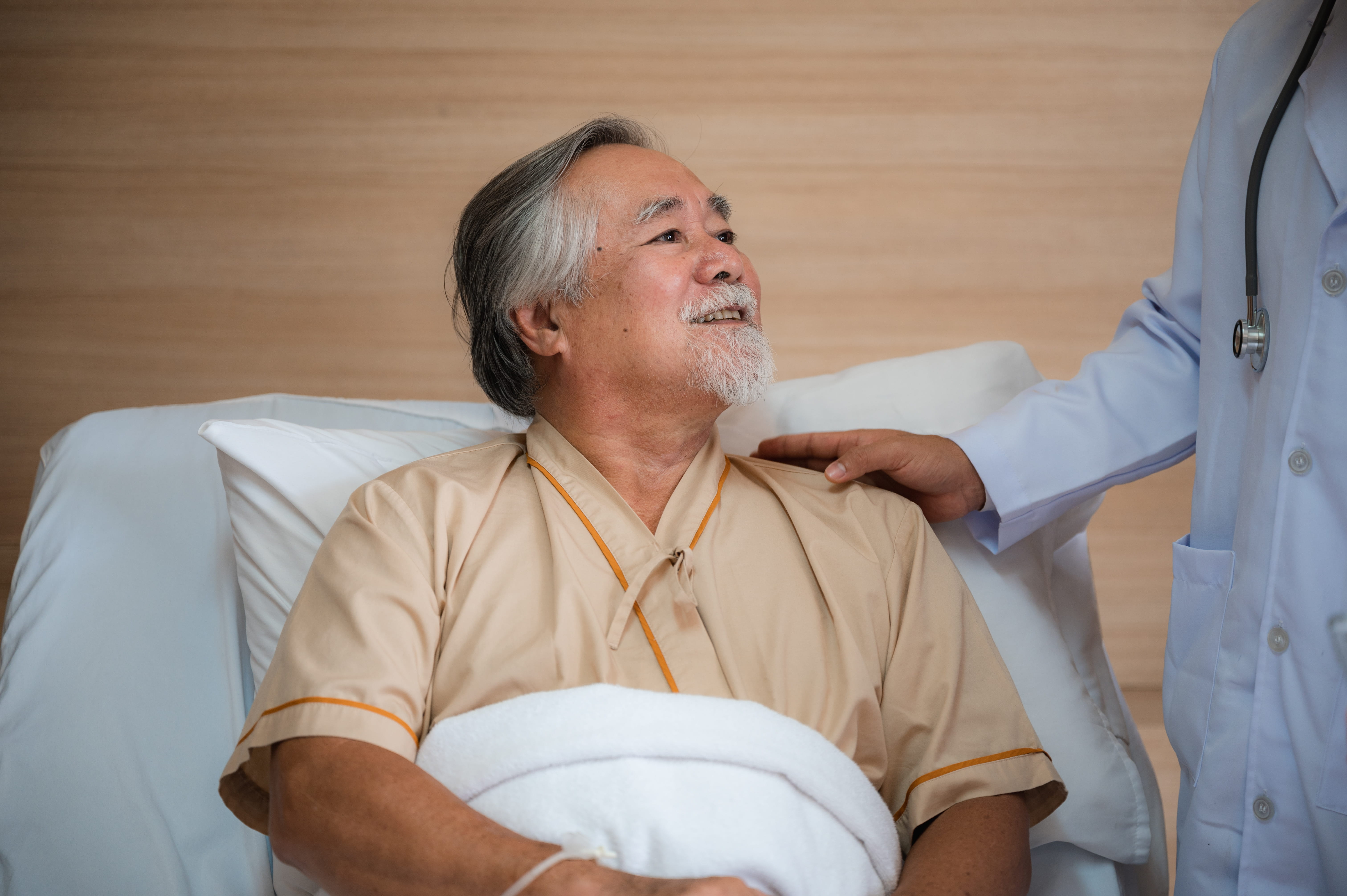 caring-doctor-visiting-senior-man-in-hospital-bed-2026-03-24-15-24-56-utc (1)