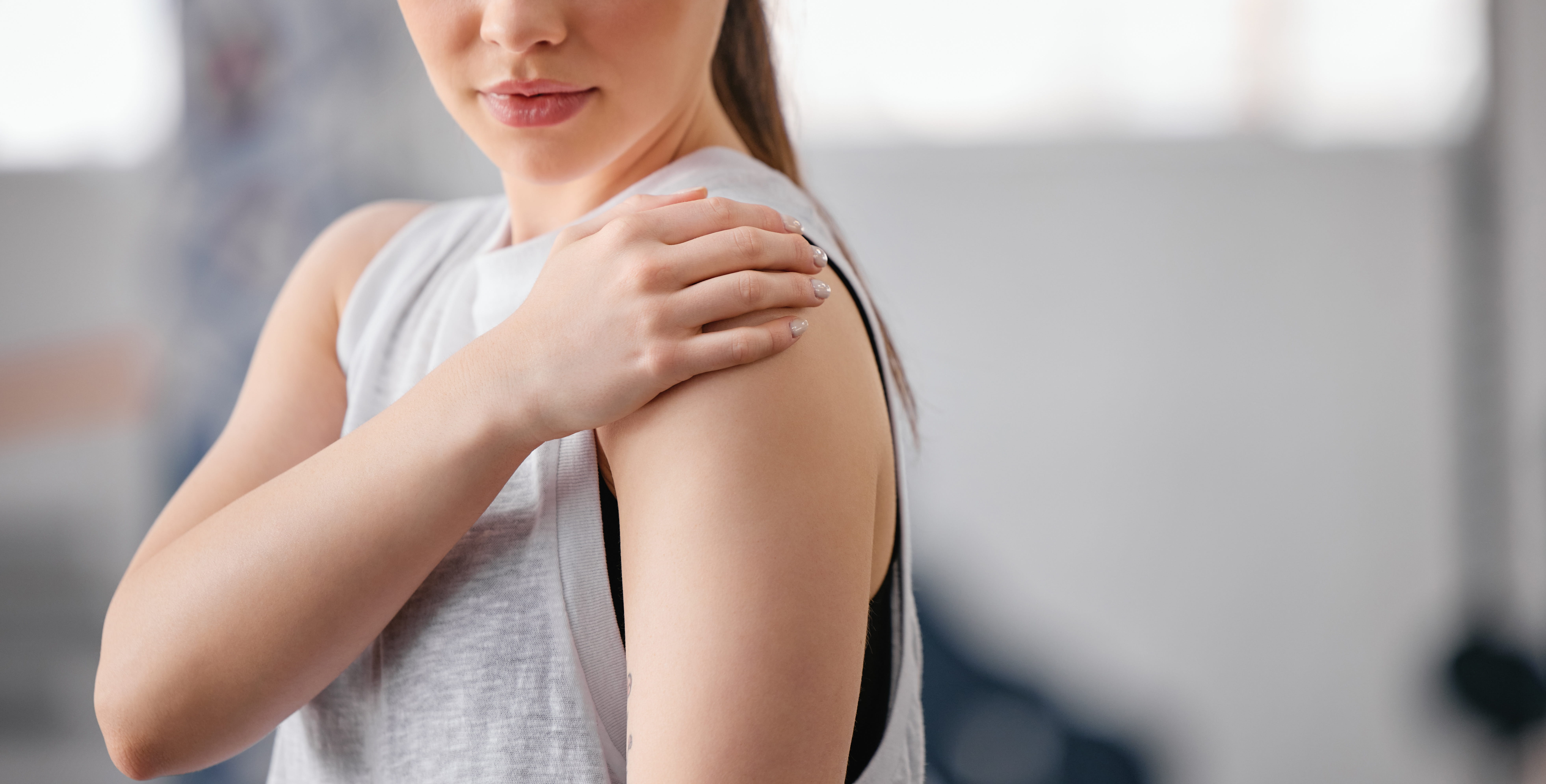 young-woman-holding-shoulder-indoors-in-natural-li-2026-03-25-02-23-17-utc (1)