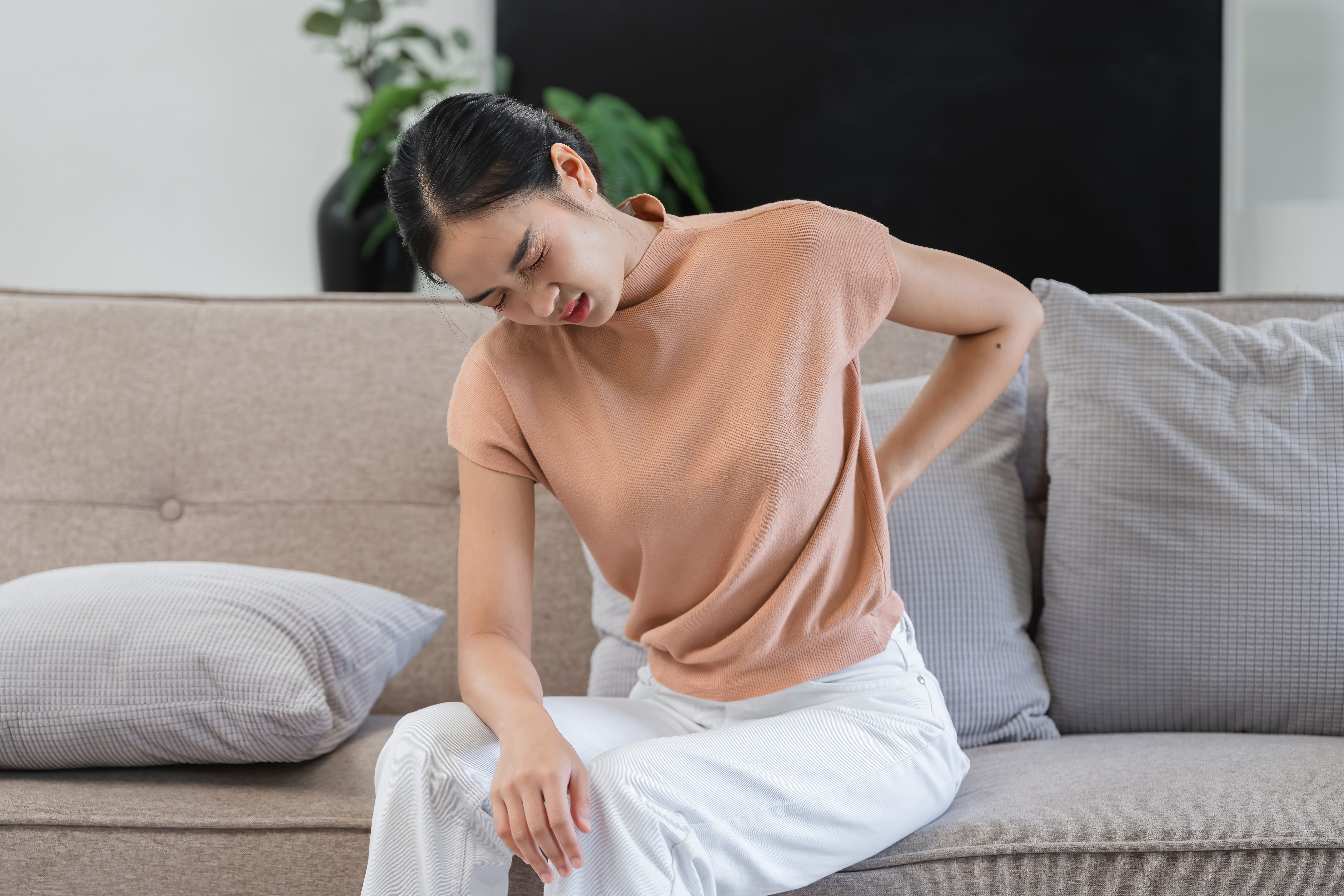 young-woman-with-discomfort-seated-on-sofa-2026-03-17-01-26-25-utc (1)